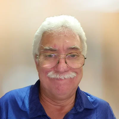 Portrait chiropractor Harold Stewart wearing a blue shirt.