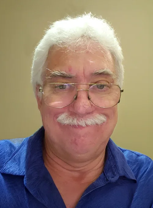 Portrait chiropractor Harold Stewart wearing a blue shirt.